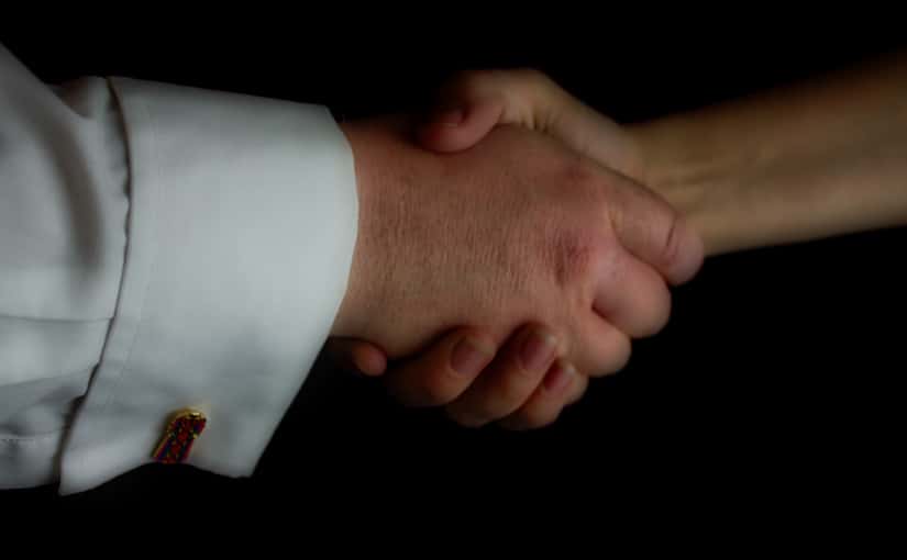 Close up of two hands shaking in greeting.